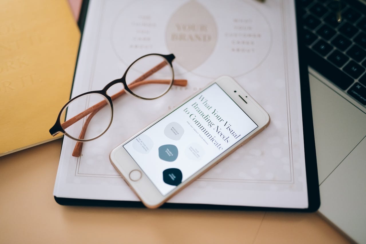 an-eyeglasses-near-the-mobile-phone-on-white-paper